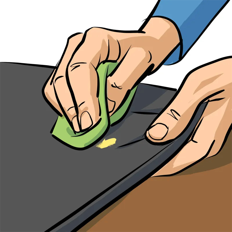 PEINTURE SUR TISSU : LES 7 ÉTAPES POUR RÉUSSIR ! 7 Main essuyant une tache de peinture sur tissu avec une lingette humide